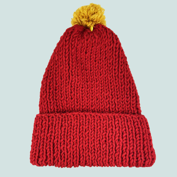 Red hat with yellow pompom